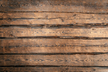 Old wooden logs wall background. Rustic wood surface