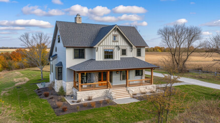 Fototapeta na wymiar Immerse yourself in the tranquility of the prairie with this cozy twostory farmhouse. With a wraparound porch and sy stone exterior this home blends seamlessly with the surrounding