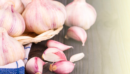Cloves of garlic on wooden background, on sunlight concept healthy lifestyle.