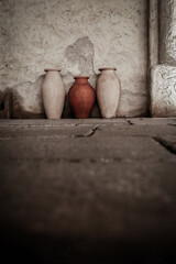 old arabic vases standing next to old wall