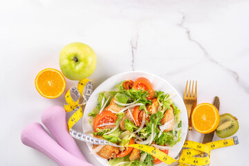 Balanced salad with fruit and fitness equipment