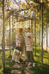 Fototapeta premium Happy family of father, mother and two sons spending time together outdoors.