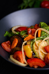 Korean food. Tofu, chicken meat with vegetables. on a black wooden background