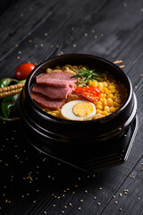 Korean food. Ramen with smoked beef. on a black wooden background