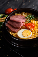 Korean food. Ramen with smoked beef. on a black wooden background