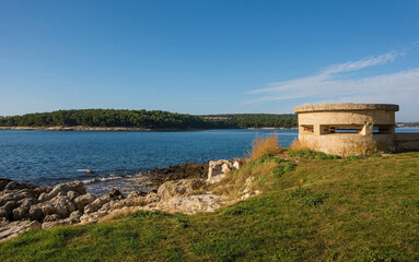 Fototapeta na wymiar A World War Two bunker on the coast of the Kasteja Forest Park - Park Suma Kasteja - in Medulin, Istria, Croatia. December