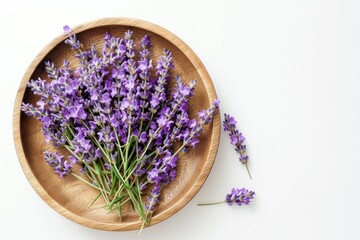 Lavender flowers in wooden plate, isolated on white, flat lay view