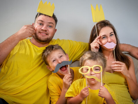 Funny family portrait with glasses, mustaches and crowns