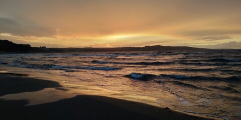 Fototapeta na wymiar SUNSET AT THE BEACH