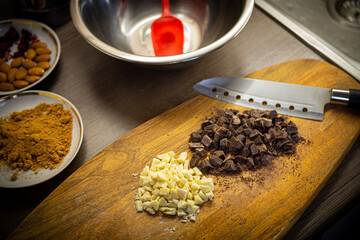 Woman cooking tasty melted chocolate on table in kitchen.