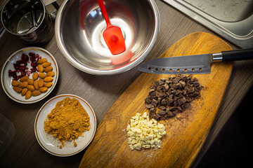 Woman cooking tasty melted chocolate on table in kitchen.