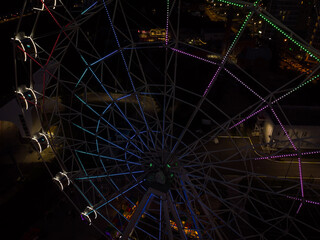 Beautiful sunset over the city with a lighted Ferris wheel.