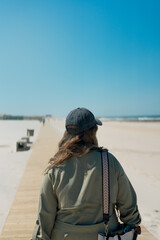 Young woman walking on the beach in Aveiro, Portugal.