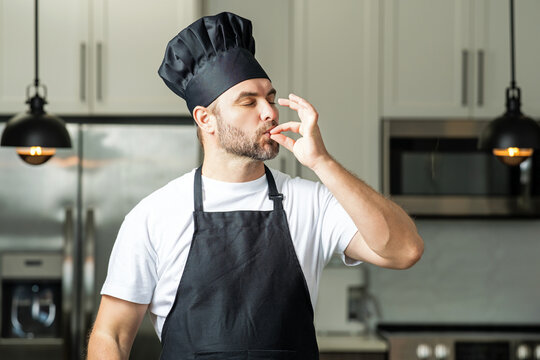 Chef cooker cooking at kitchen. Chefs with sign of perfect food in home kitchen. Chef man cooking, showing sign for delicious. Chefs cook in hat and apron on kitchen.