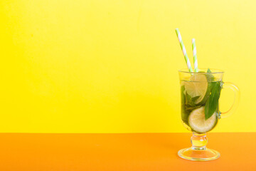 Mojito summer refreshing cocktail with ice and mint. mojito cocktail with lime, lemon and mint in a tall glass with a stick