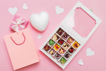 Valentine day composition: sweet candy, with gift boxes with bow and red felt hearts, photo...