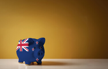 Piggy bank with painting of New Zealand flag. The problem is in the economy. Economic crisis. Saving money concept.