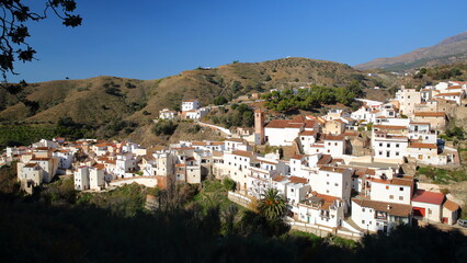 General view towards the village of Salares, Axarquia, Malaga province, Andalusia, Spain, with whitewashed houses and surrounded by mountains and trees