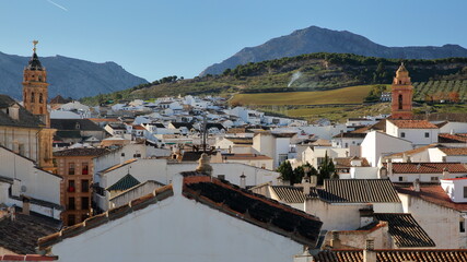 Fototapeta premium Aerial view of the historic center of Antequera, Malaga province, Andalusia, Spain, with rooftops and the clock tower of San Sebastian church on the left side