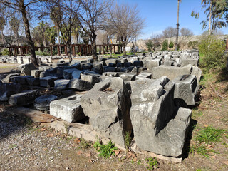 Stone ruins of an ancient city, concrete pieces of destroyed buildings with decorative ornaments
