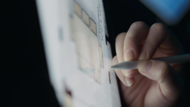 Architect drawing a house floor plan on a tablet. Close up, slow motion.