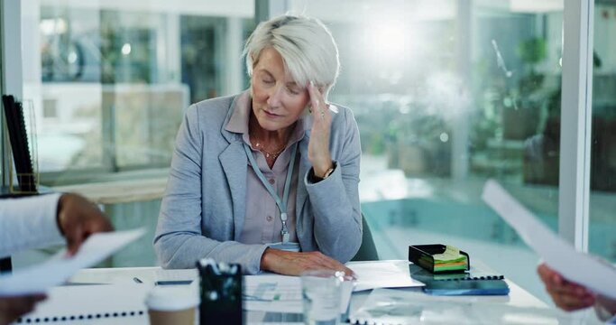 Business meeting, headache and senior woman with stress in office with tax, audit or documents. Anxiety, migraine and elderly hospital ceo overwhelmed by deadline, admin or medical compliance fail