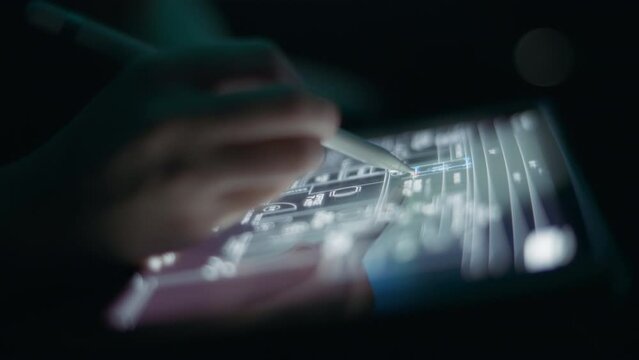 Architect drafting a house layout using a pen on a tablet. Close up, slow motion.