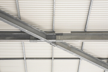New metal roof with precast steel structure with pillars, steel beams and bolts in galvanized steel