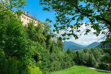 Fototapeta na wymiar Panoramic view of medieval castle Rabenstein on a hill in Frohnleiten, Murtal, Styria (Steiermark), Austria. Travel destination sunny day in summer. Surrounded by idyllic forest in foothills of Alps