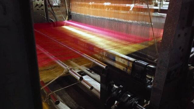 Making bright silk cloth for a Sari on a loom in Varanasi, India - With audio