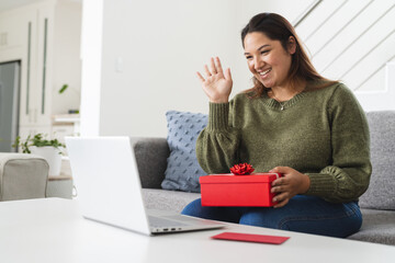 Young plus size biracial woman enjoys a virtual celebration at home