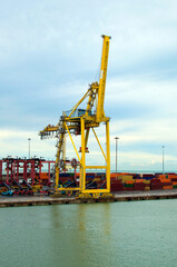 Detailed view of crane bridge for unloading or loading containers to the cargo freight ship from port area. Import, export and business logistic. International water transport