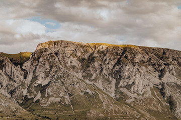 Close-up shot of Piatra Secuiului Cliffs in Rimetea, the pathways between the meadow