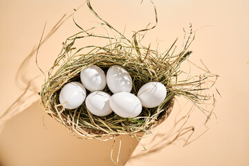 Wicker basket with farm natural white eggs.