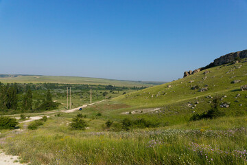 Fototapeta na wymiar A picturesque view of the green steppe hills, pastures stretching into the distance.