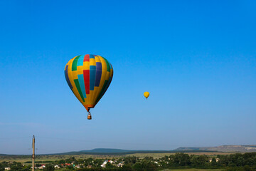 Colorful hot air balloon flying on sky.