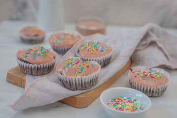 Chocolate cupcakes decorated with fresh cream raspberries 