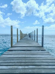 Wooden bridge on the tropical beach and blue sky summer background