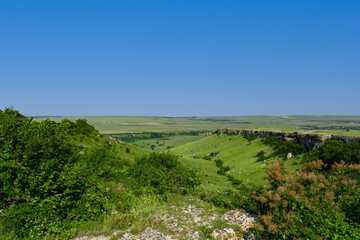 A picturesque view of the green steppe hills, pastures stretching into the distance.