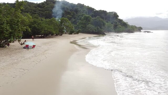 aerial view of beautiful caribbean beach in the Venezuela coast. Drone shot of white sand and pristine tropical landscape with wild forest in the town of Chuspa