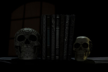 Antique embossed books with sculptured skull book ends with Smokey and spooky background Handmade