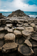 A dramatic landscape photo featuring the Giant's Causeway, a UNESCO World Heritage Site in Northern Ireland.