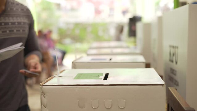 Resident put ballot paper in to a box during Indonesian Pemilu elections