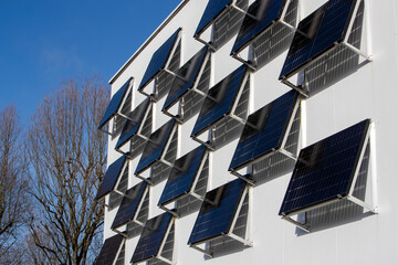 Panneaux solaires installés sur un grand mur blanc en ville