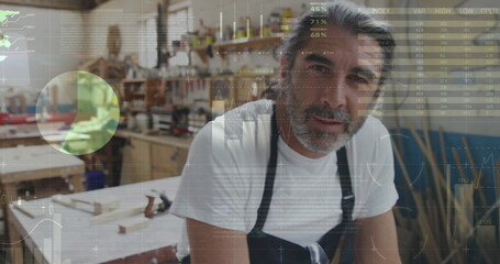 Two men building in a workshop with graphs and stats