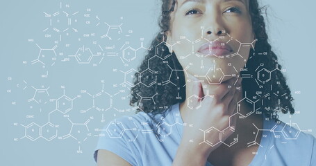 Image of chemical structures over biracial woman thinking