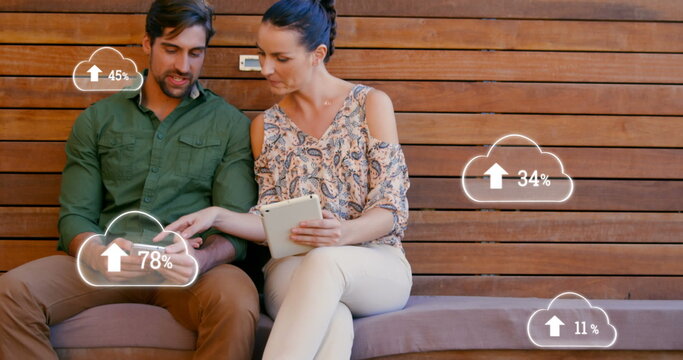 Image of digital interface with cloud icons with numbers growing and data processing over couple usi - Powered by Adobe