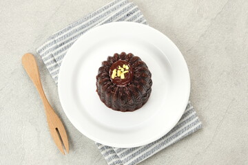 Chocolate cake topped with cream cheese and melted chocolate
