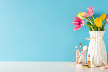 Marking 8 March, a side view of a table holding women's favorites: precious jewelry, beauty brushes, lipstick, eyeshadow, and fresh tulips, pastel blue background, empty text space