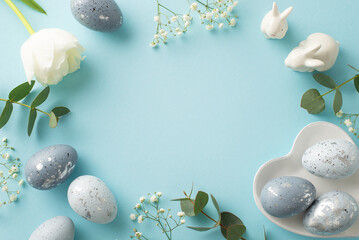 Easter decor concept: Top view of charcoal grey eggs in a heart dish, porcelain bunnies,...
